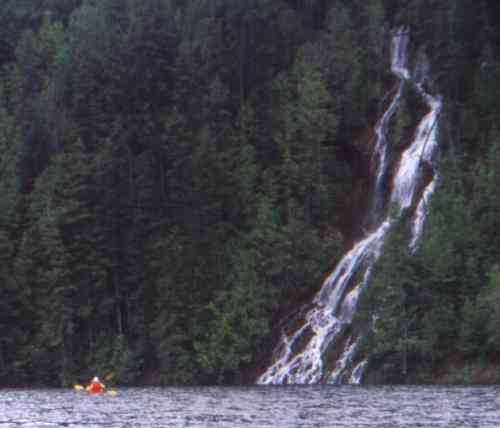Mountainside waterfall cascading into Seymour Arm